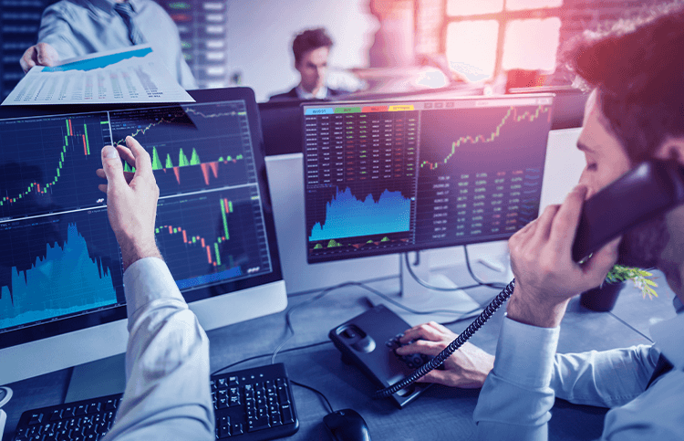 Computer trading screens with brokers in action. Computer trading screens with brokers in action.
